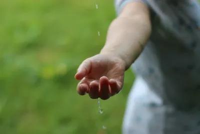 Water dropping onto a hand